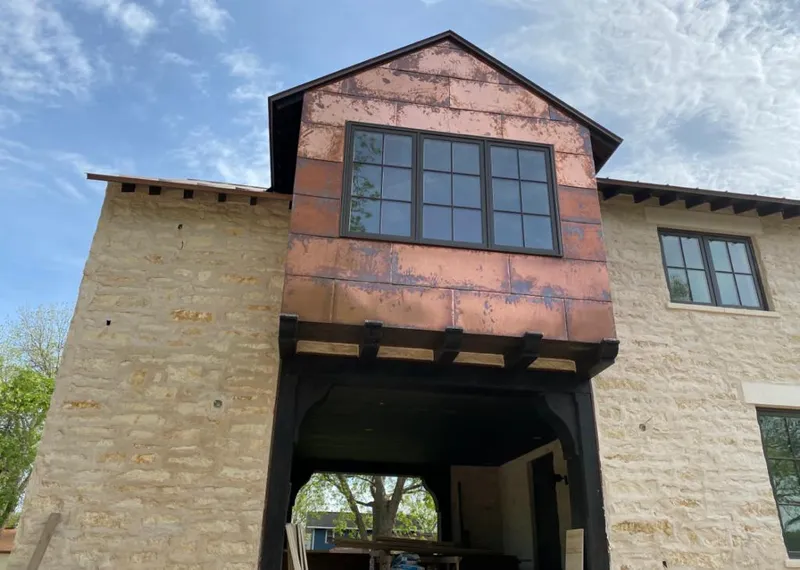 Copper metal panel facade on a stone building for Metal Roof Coating in Muleshoe