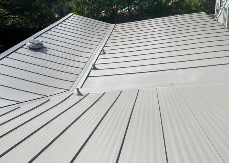 Solar attic fan installed on a metal roof for Roof Ventilation in Muleshoe